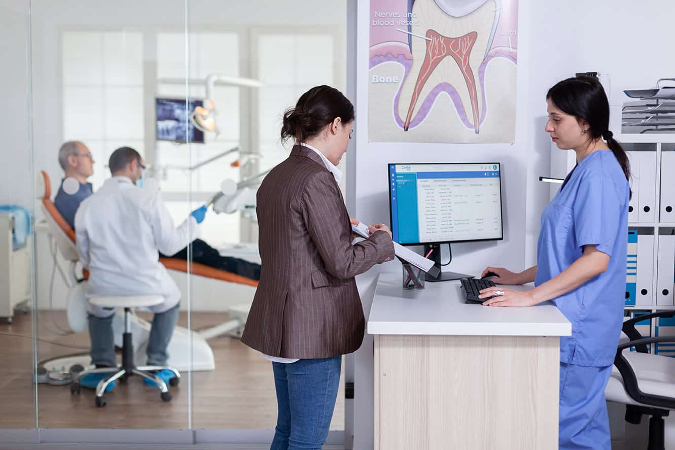 Woman filling out forms in dental office